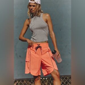 Free People Movement Rip Tide Outlander Shorts in Neon Coral with Navy Pop